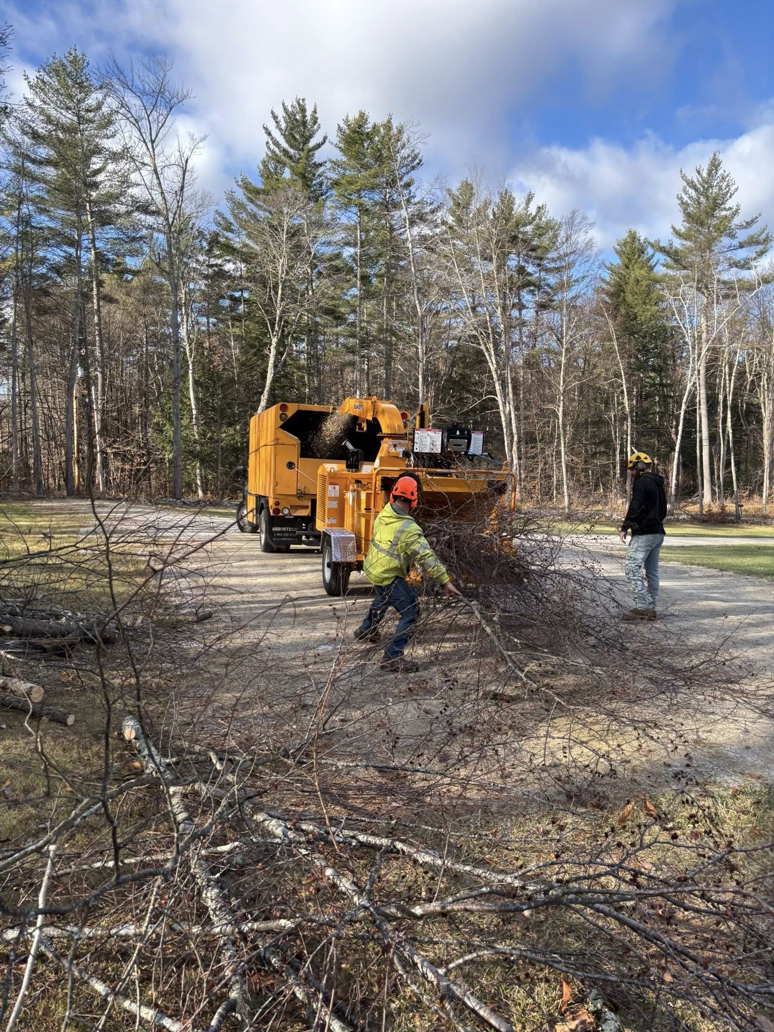Storm cleanup crew clearing branches at Vermont tree service job