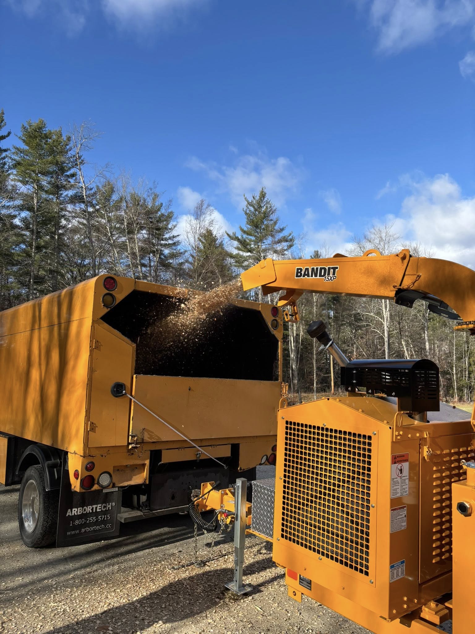 Professional wood chipper in action at Vermont tree service job